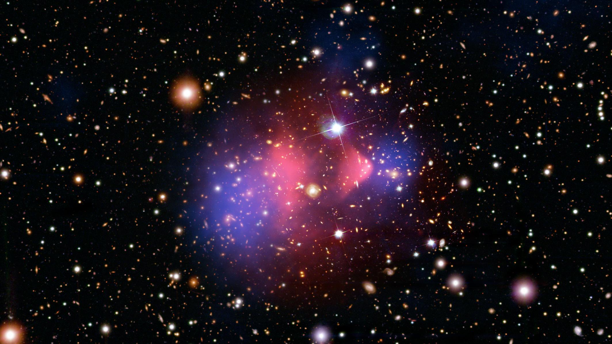 Bullet Cluster composite showing lensing mass in blue and hot X-ray gas in pink